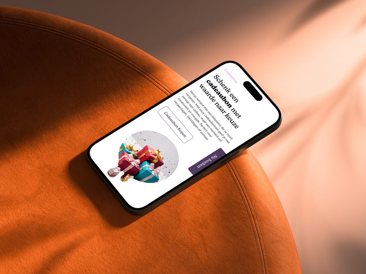 Smartphone toont cadeaubon aankoop op bruine stoel.